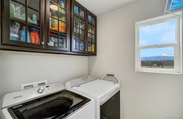 washroom with cabinet space and washer and dryer