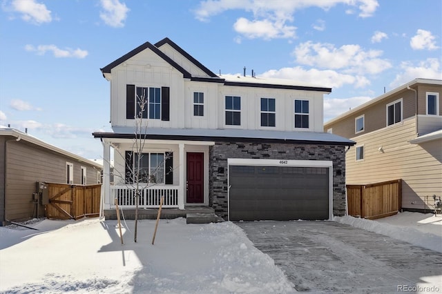 view of property with a garage and covered porch