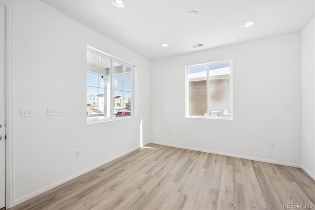 spare room featuring light hardwood / wood-style floors