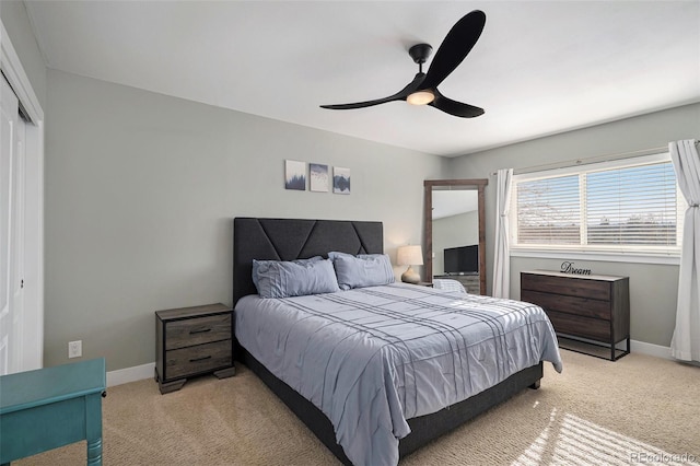 bedroom featuring a closet, baseboards, and light colored carpet