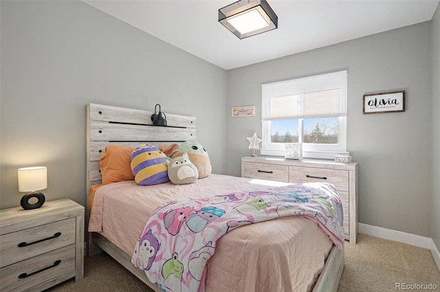 bedroom with baseboards and carpet