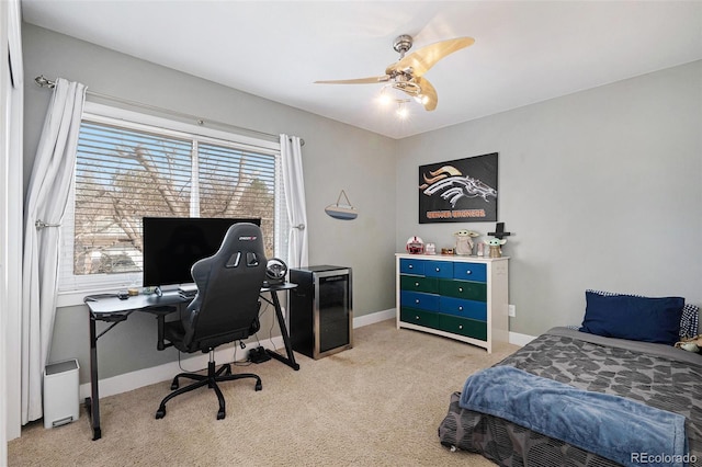 bedroom featuring light colored carpet, baseboards, and ceiling fan