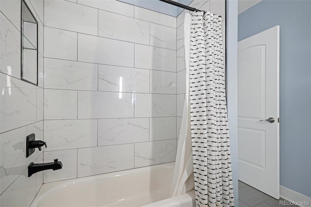 bathroom with shower / tub combo with curtain and baseboards