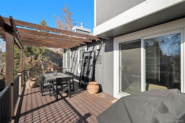 wooden deck with a pergola and outdoor dining area