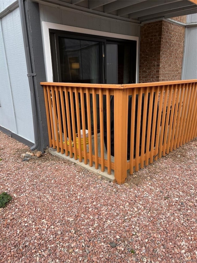 exterior space with a deck and brick siding