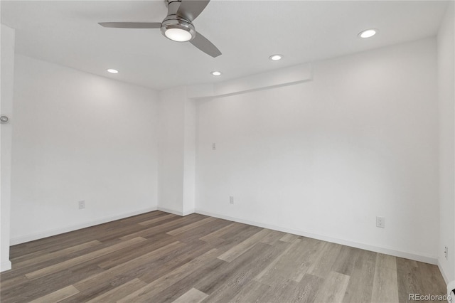 empty room with hardwood / wood-style flooring and ceiling fan