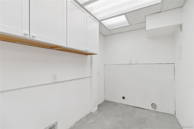 laundry room featuring electric dryer hookup and cabinets