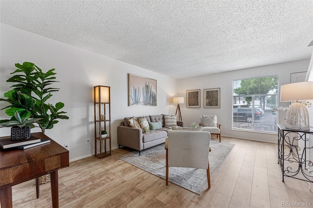 living room featuring a textured ceiling and light hardwood / wood-style flooring