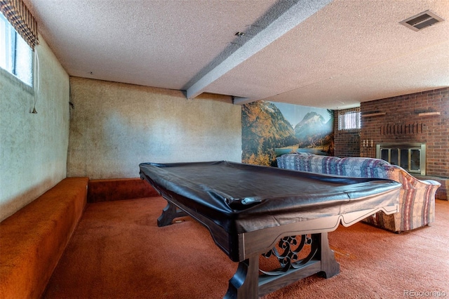 rec room with plenty of natural light, billiards, beamed ceiling, and a fireplace