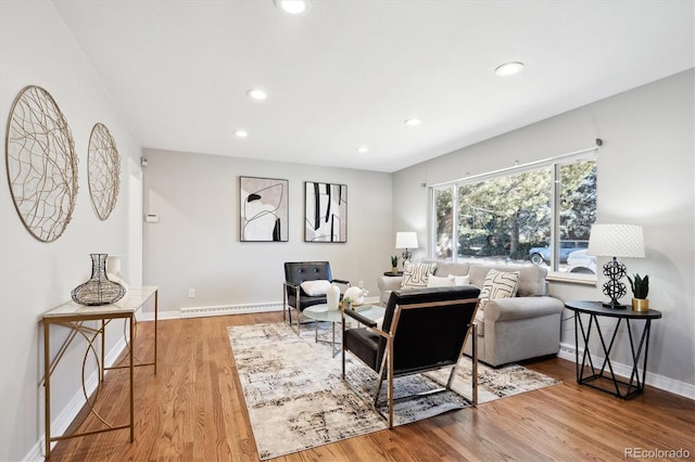 living room featuring a baseboard radiator and hardwood / wood-style floors