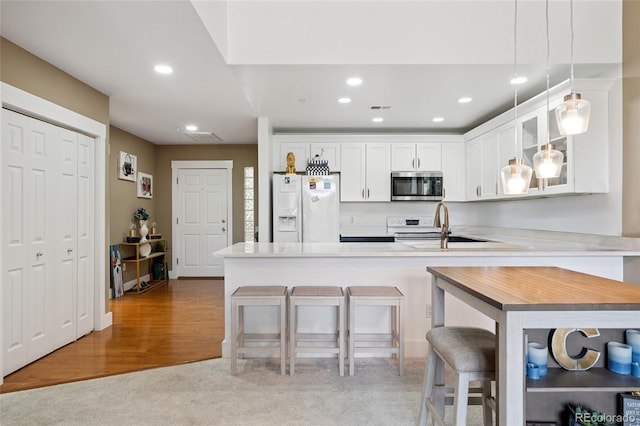 6000 W Floyd Ave Unit 214, Denver, CO 80227 - kitchen featuring white appliances, a peninsula, glass insert cabinets, recessed lighting, and white cabinetry
