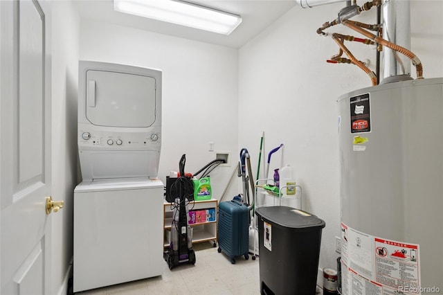 6000 W Floyd Ave Unit 214, Denver, CO 80227 - laundry room with water heater, stacked washer / drying machine, and light flooring