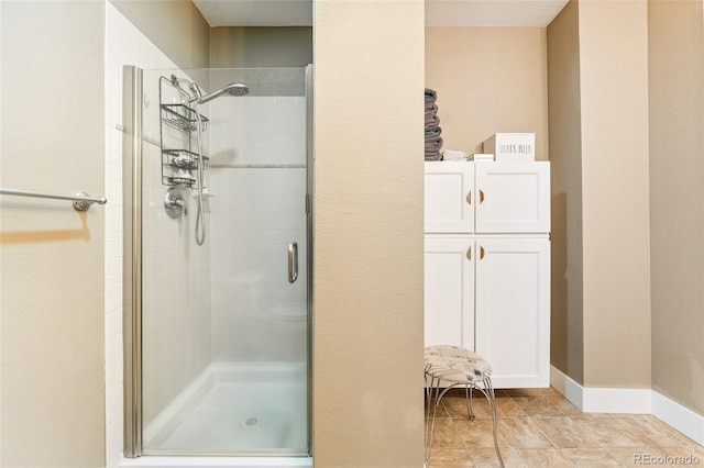 6000 W Floyd Ave Unit 214, Denver, CO 80227 - full bathroom featuring a shower stall and tile patterned flooring