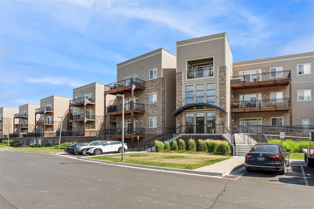 6000 W Floyd Ave Unit 214, Denver, CO 80227 - view of apartment building / complex with uncovered parking