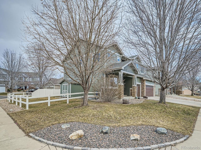 obstructed view of property featuring a garage, fence, concrete driveway, and a front yard