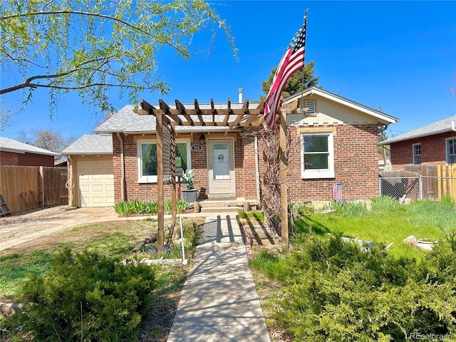 bungalow-style home featuring fence, a pergola, an attached garage, and brick siding