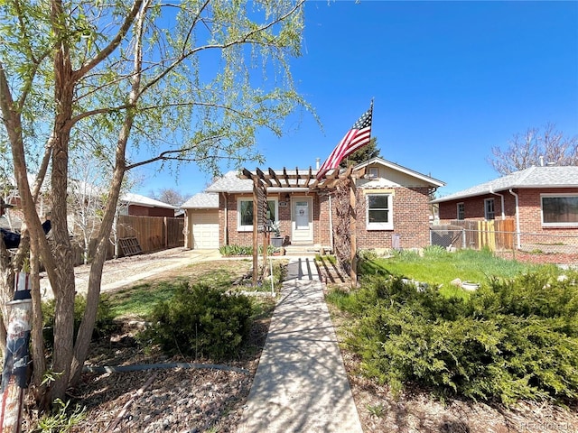 view of front facade with brick siding, a garage, fence, and driveway
