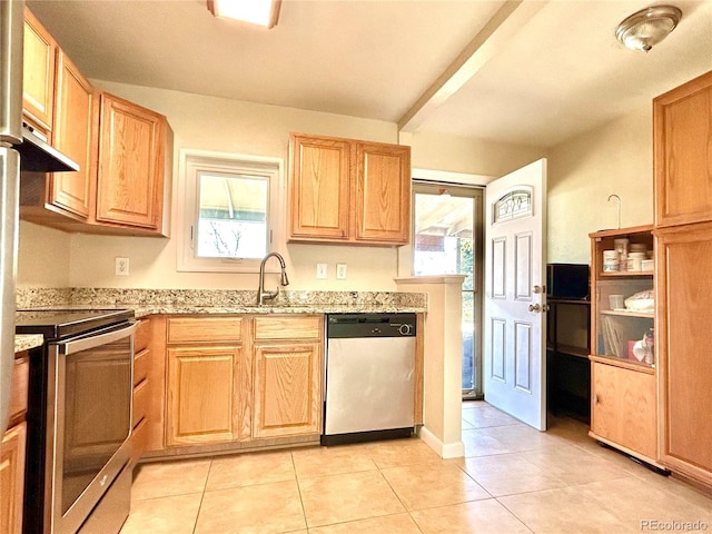 kitchen featuring light tile patterned flooring, appliances with stainless steel finishes, light stone counters, light brown cabinets, and under cabinet range hood