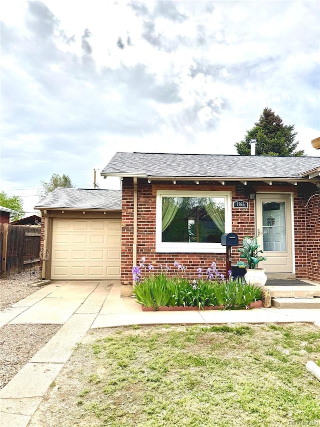 1965 Havana St, Aurora, CO 80010 - single story home featuring brick siding, a garage, concrete driveway, and roof with shingles