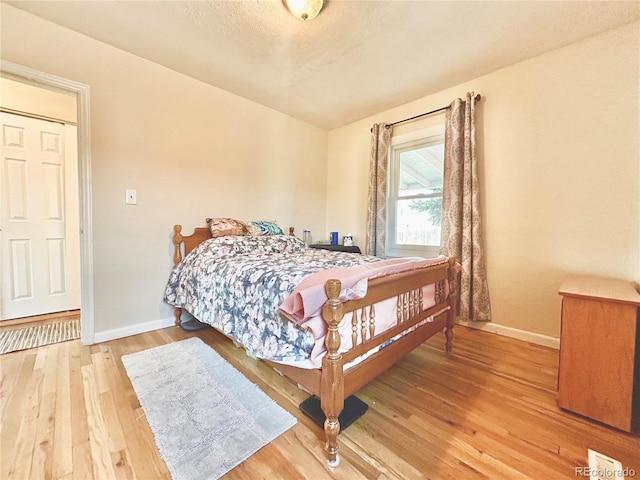 1965 Havana St, Aurora, CO 80010 - bedroom with baseboards and wood finished floors