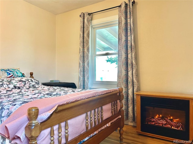 1965 Havana St, Aurora, CO 80010 - bedroom with wood finished floors and a glass covered fireplace