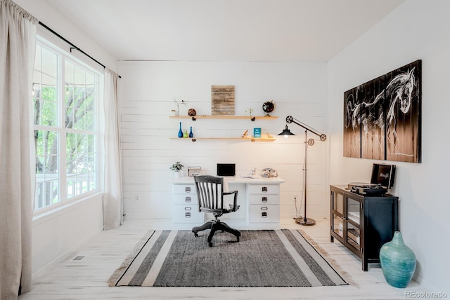 8367 Devinney St, Arvada, CO 80005 - home office with light wood-style floors and wood walls