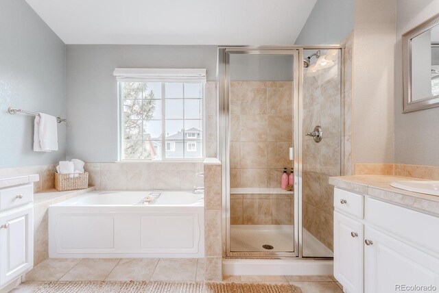 8367 Devinney St, Arvada, CO 80005 - bathroom with vanity, a garden tub, a stall shower, and tile patterned flooring