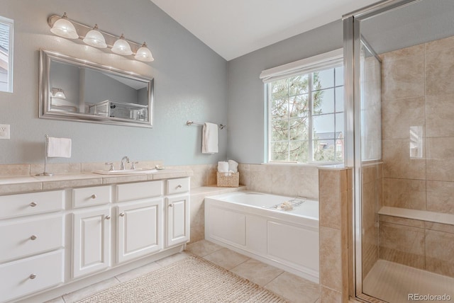 8367 Devinney St, Arvada, CO 80005 - bathroom with lofted ceiling, tile patterned floors, vanity, a garden tub, and a stall shower
