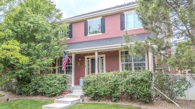 8367 Devinney St, Arvada, CO 80005 - view of front of home with covered porch and roof with shingles