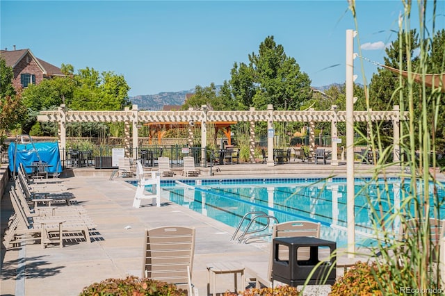 8367 Devinney St, Arvada, CO 80005 - community pool with a pergola, a mountain view, and a patio