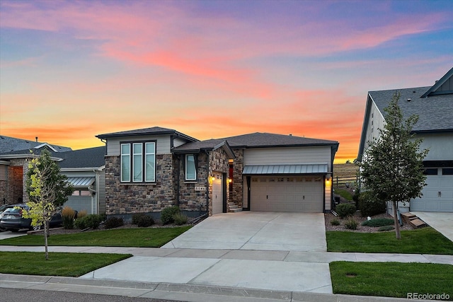 view of front of property with a yard and a garage