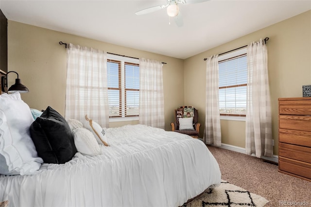 carpeted bedroom with baseboards and ceiling fan