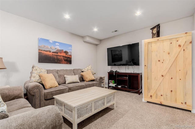 living area with recessed lighting, visible vents, and light carpet