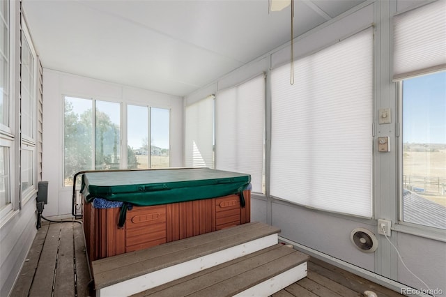 sunroom / solarium with a hot tub