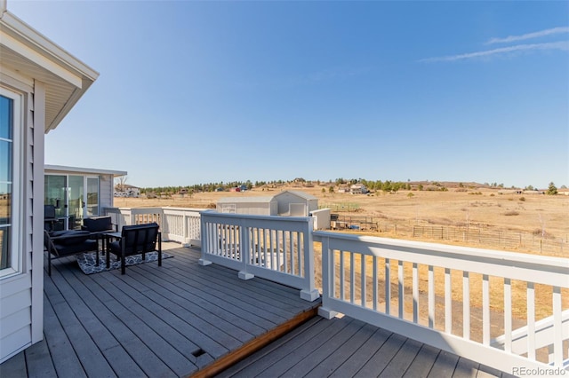 wooden deck featuring a rural view