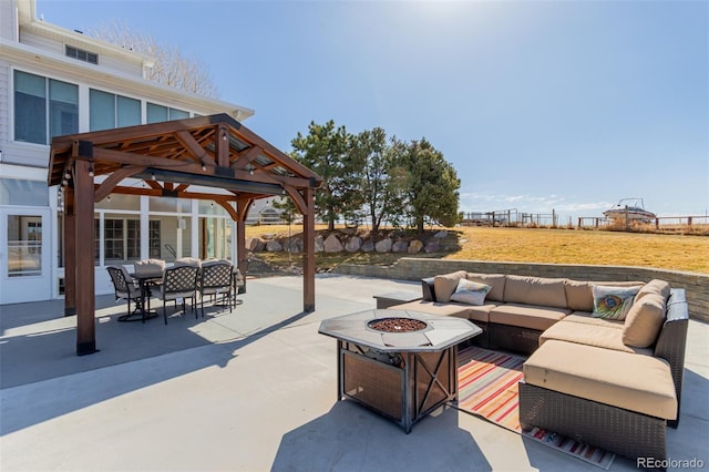 view of patio / terrace featuring an outdoor living space with a fire pit, a gazebo, and fence