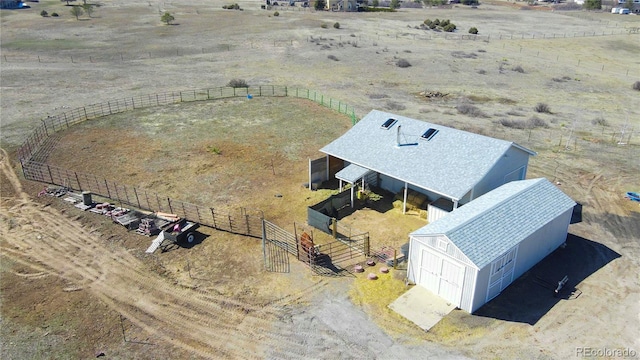 birds eye view of property with a rural view