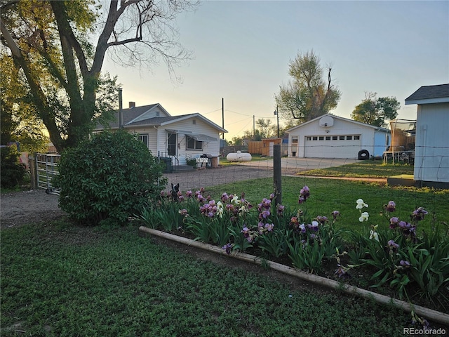 24797 Pleasant Hill Ave, Galeton, CO 80622 - yard at dusk featuring an outdoor structure, a garage, and driveway