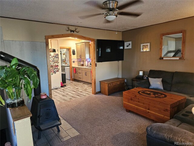 24797 Pleasant Hill Ave, Galeton, CO 80622 - living area with a ceiling fan, light colored carpet, and a textured ceiling