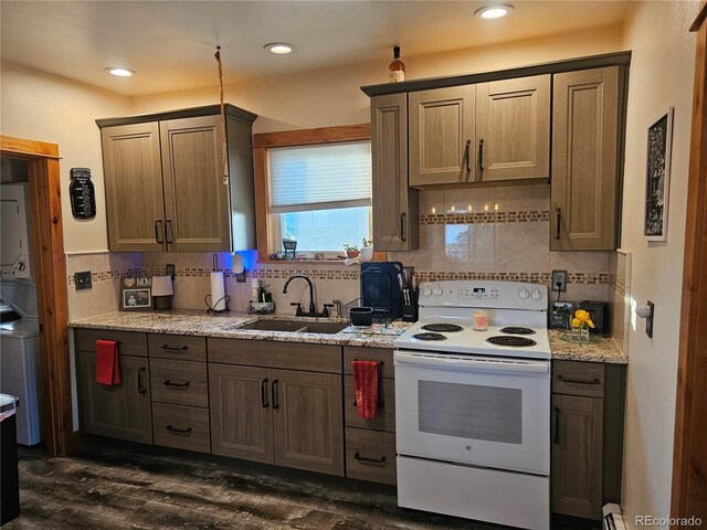 24797 Pleasant Hill Ave, Galeton, CO 80622 - kitchen with white electric range oven, a sink, stacked washer and clothes dryer, backsplash, and recessed lighting