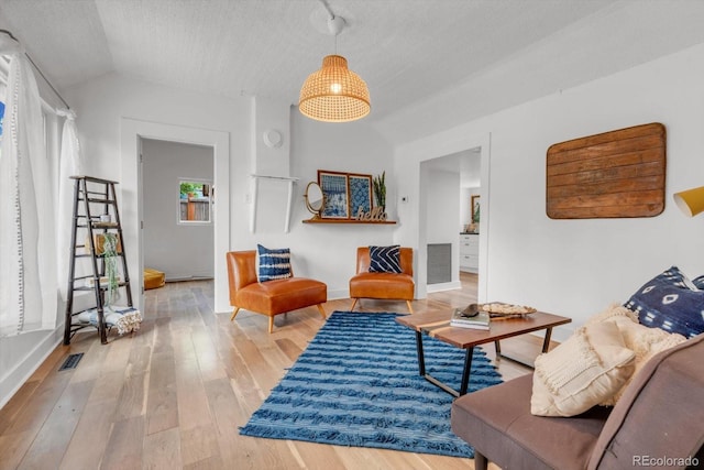 211 E Emma St, Lafayette, CO 80026 - living area with lofted ceiling, hardwood / wood-style floors, and a textured ceiling