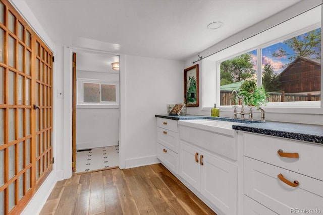 211 E Emma St, Lafayette, CO 80026 - full bath with vanity, hardwood / wood-style floors, and baseboards