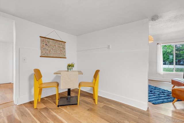 211 E Emma St, Lafayette, CO 80026 - dining area featuring wood finished floors and baseboards