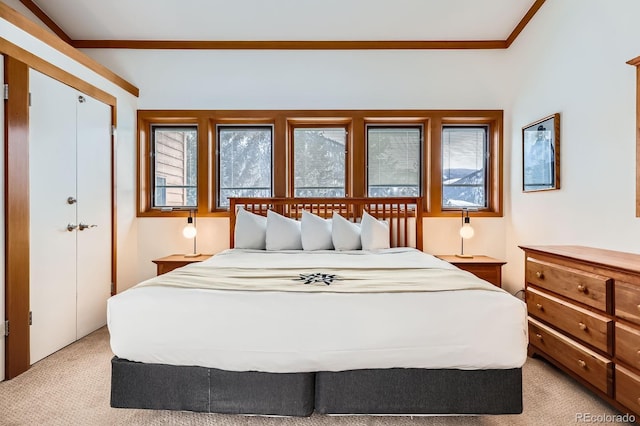 bedroom with light colored carpet and crown molding