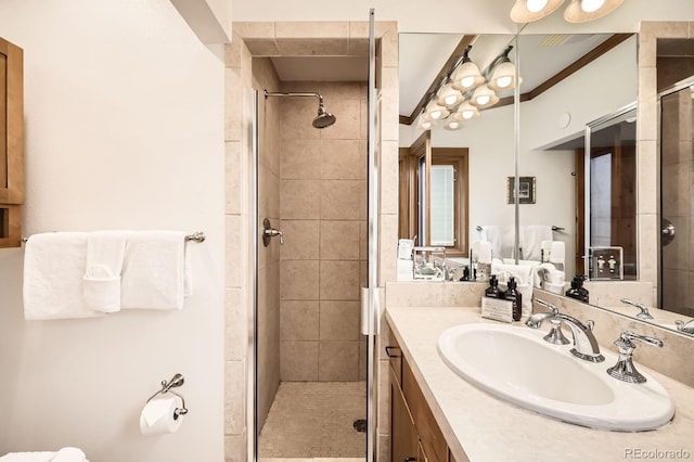 bathroom with vanity and a shower with door