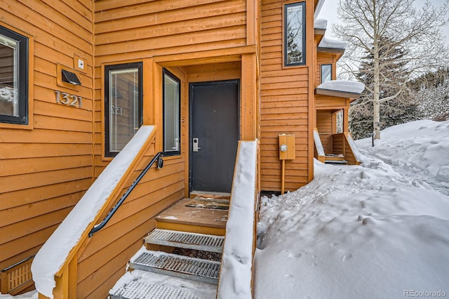 view of snow covered property entrance