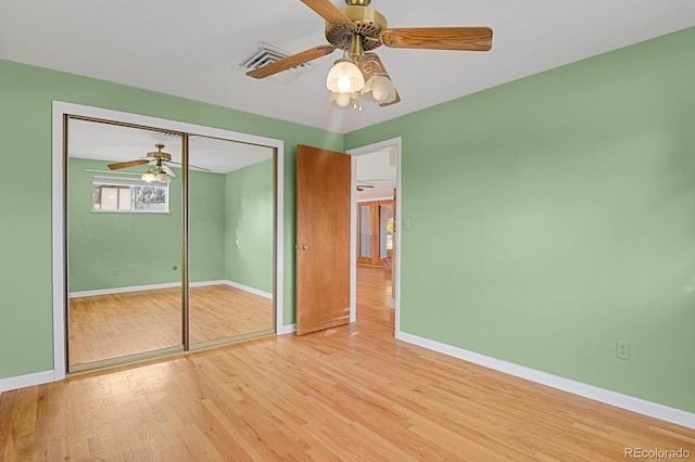 unfurnished bedroom with light hardwood / wood-style floors, a closet, and ceiling fan