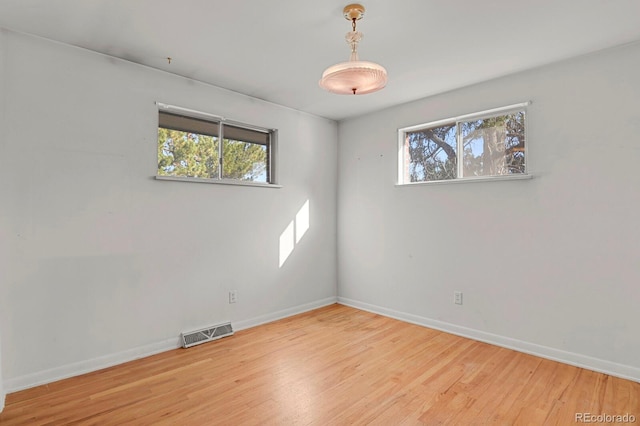 spare room featuring light hardwood / wood-style flooring