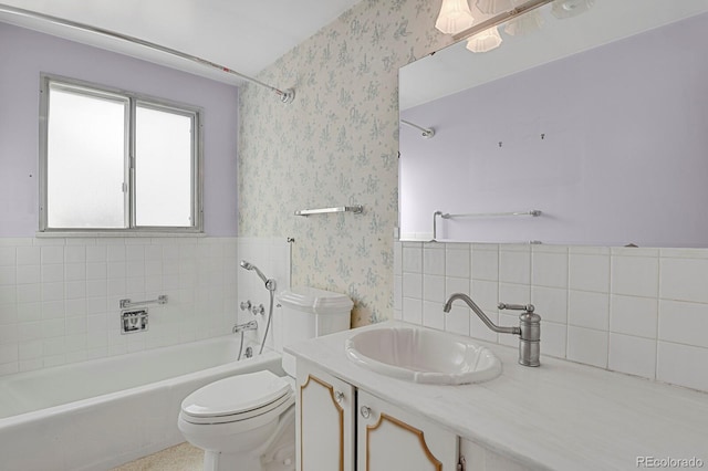 bathroom with vanity, tile walls, and toilet