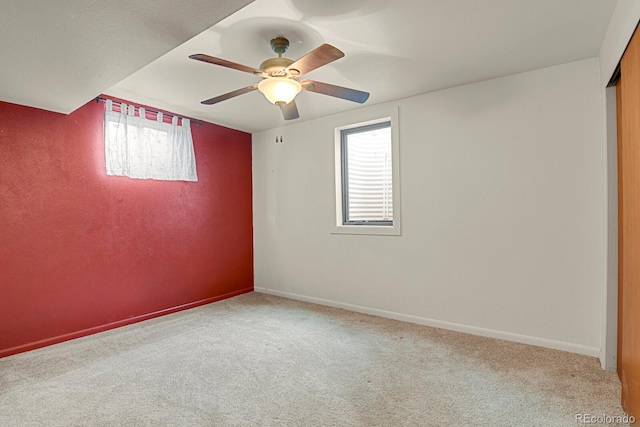 carpeted spare room with ceiling fan and a healthy amount of sunlight